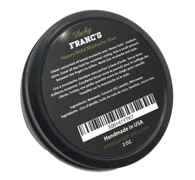 Lucky Franc's unscented mustache wax being warmed between fingers for precise styling.