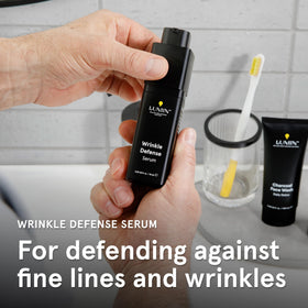 Man applying Lumin Wrinkle Defense Serum after a shower