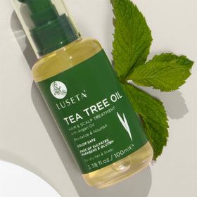 L Luseta Tea Tree Oil bottle with label highlighting nourishing properties.