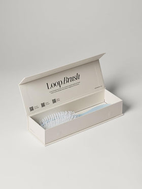 Luxy Loop Extensions Brush in use on hair lengths for quick, tangle-free styling