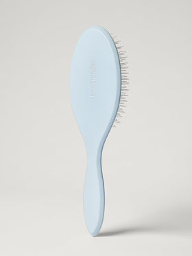 Luxy Loop Extensions Brush nylon loop bristles close-up showing gentle detangling on wefts
