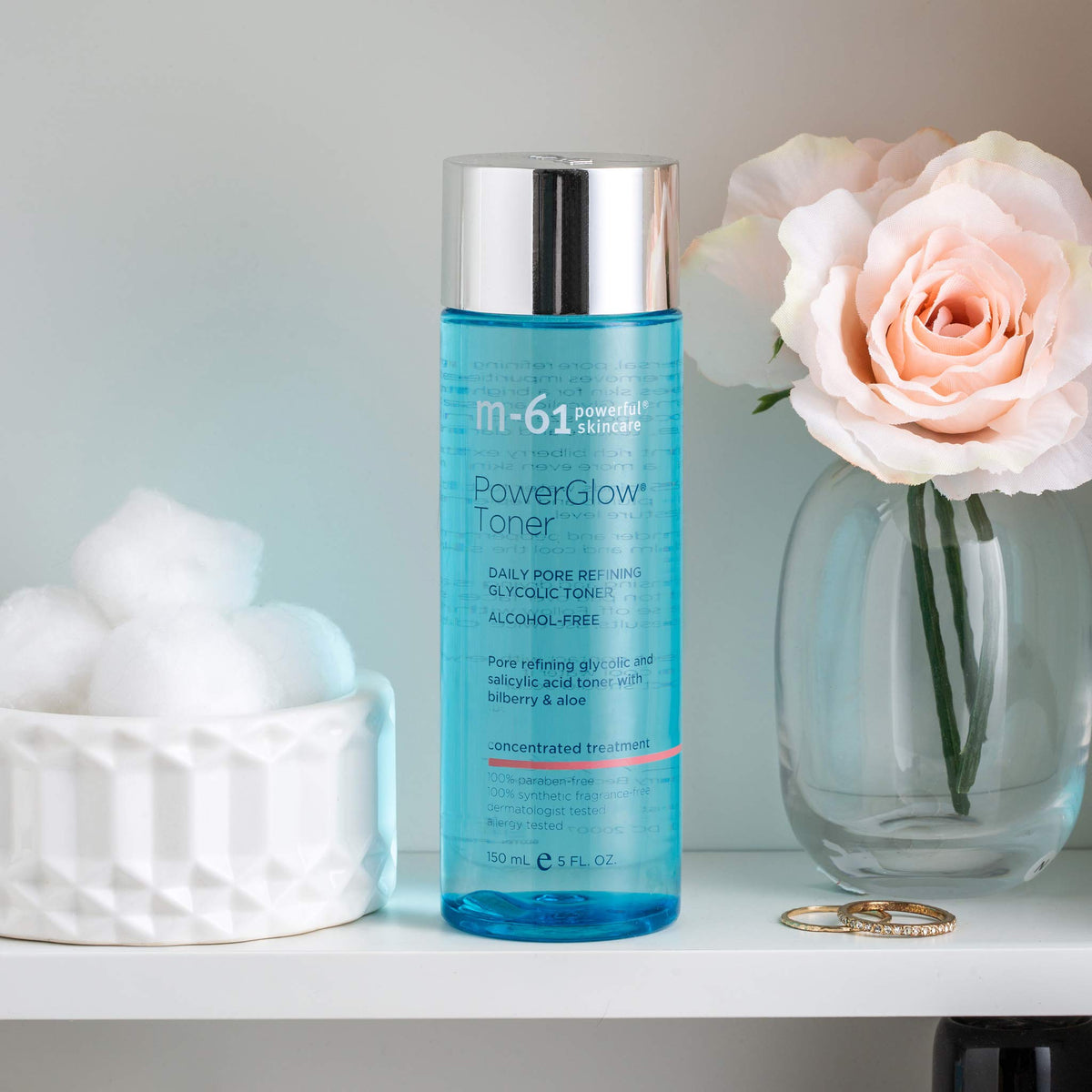 m-61 PowerGlow Toner applying on skin demonstrates balanced, clarified complexion.