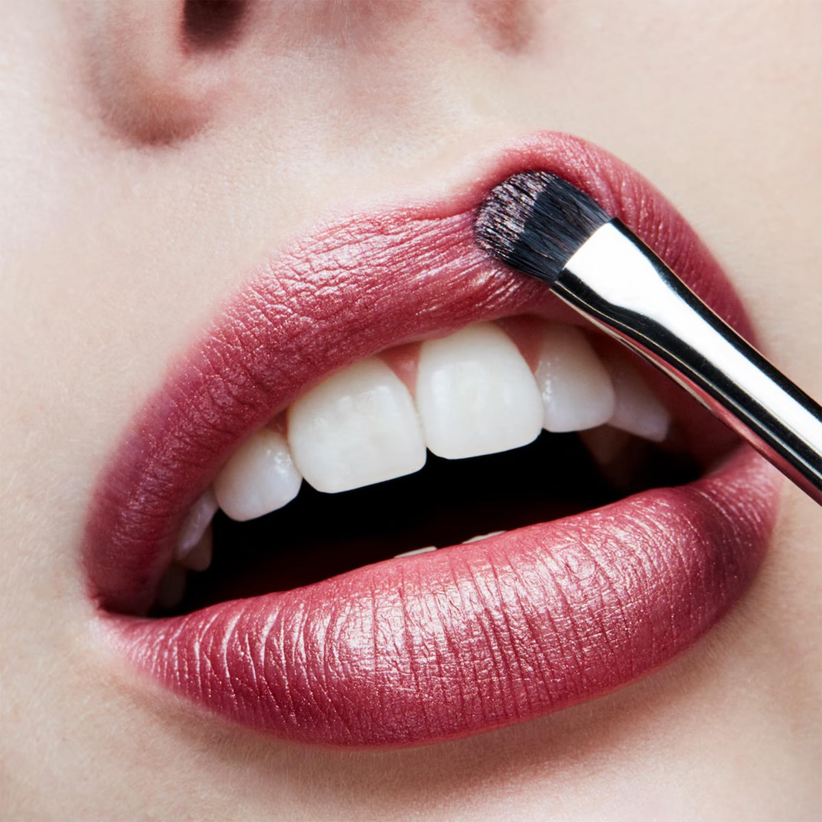 MAC Frost Lipstick Plum Dandy on lips creates a subtle pearl glow for evening looks.