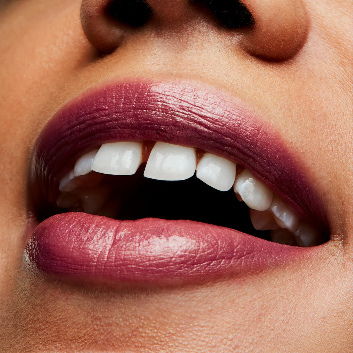 MAC Frost Lipstick Plum Dandy close-up highlighting the pearlescent finish in bright light.