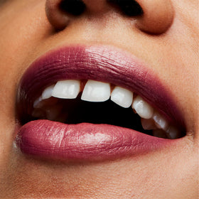 MAC Frost Lipstick Plum Dandy close-up highlighting the pearlescent finish in bright light.