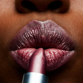 MAC Frost Lipstick Plum Dandy swatch on arm demonstrates buildable color for everyday or evening looks.