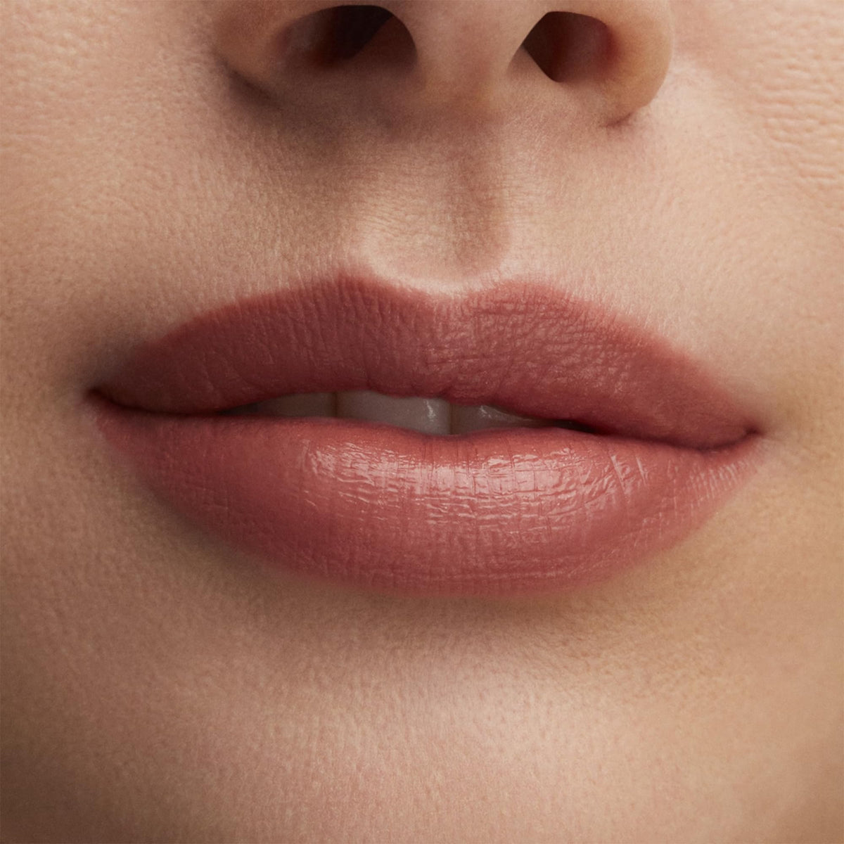 MAC Lustre Lipstick Hug Me during application highlights smooth glide for quick touch-ups.