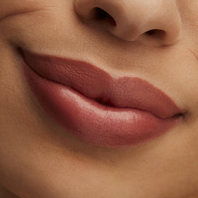MAC Hug Me lipstick bullet closeup shows reflective finish and compact design.