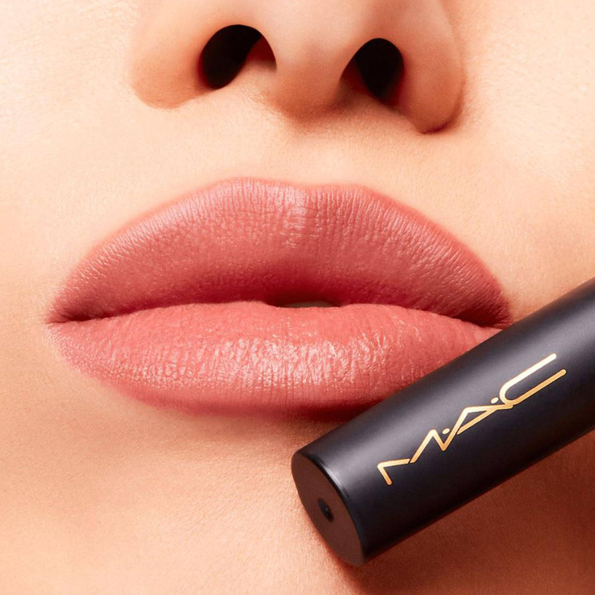 Twist-up applicator on MAC Powder Kiss Slim Stick for precise application.