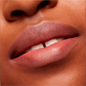 Lip swatch on skin displaying Over The Taupe shade and muted tone.