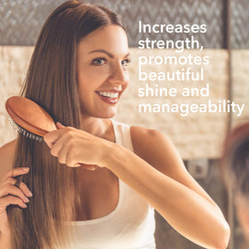 Macadamia Natural Oil Spray mist dispensing action highlights smooth frizz-control benefits.