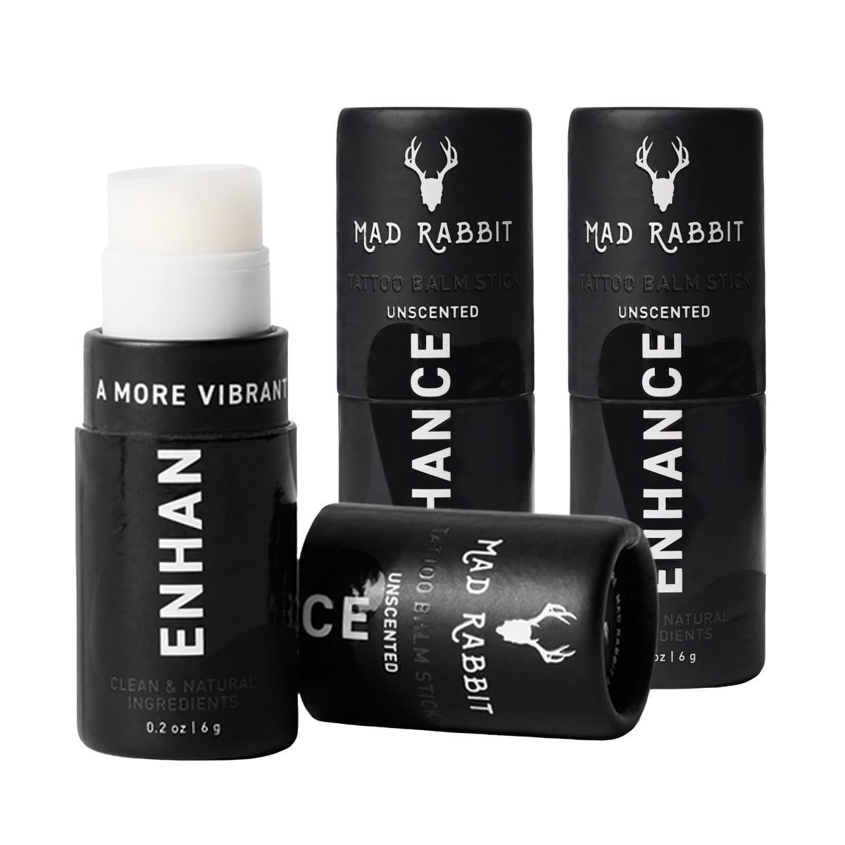 Mad Rabbit Enhance Tattoo Balm Stick being applied for smooth, protective moisture on tattooed skin.