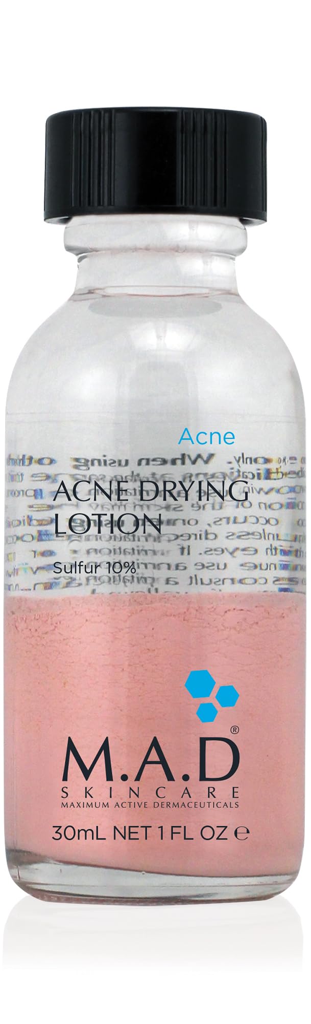 M.A.D Skincare Acne Drying Lotion bottle on nightstand for overnight blemish care.