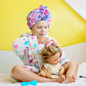 MADHOLLY towel with button keeps wrap secure during use.