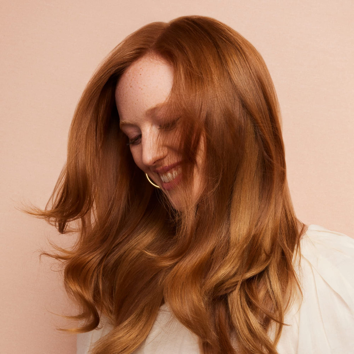 Product being applied to hair for gentle conditioning and color protection