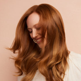 Product being applied to hair for gentle conditioning and color protection