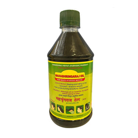Mahabhringaraj Oil bottle pour showing herbal formula for hair care.