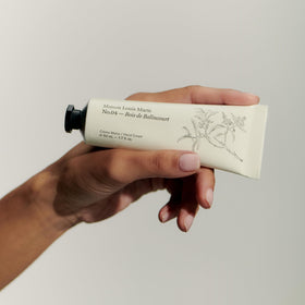 Maison Louis Marie No.04 Bois De Balincourt hand cream being applied for quick daily moisture.
