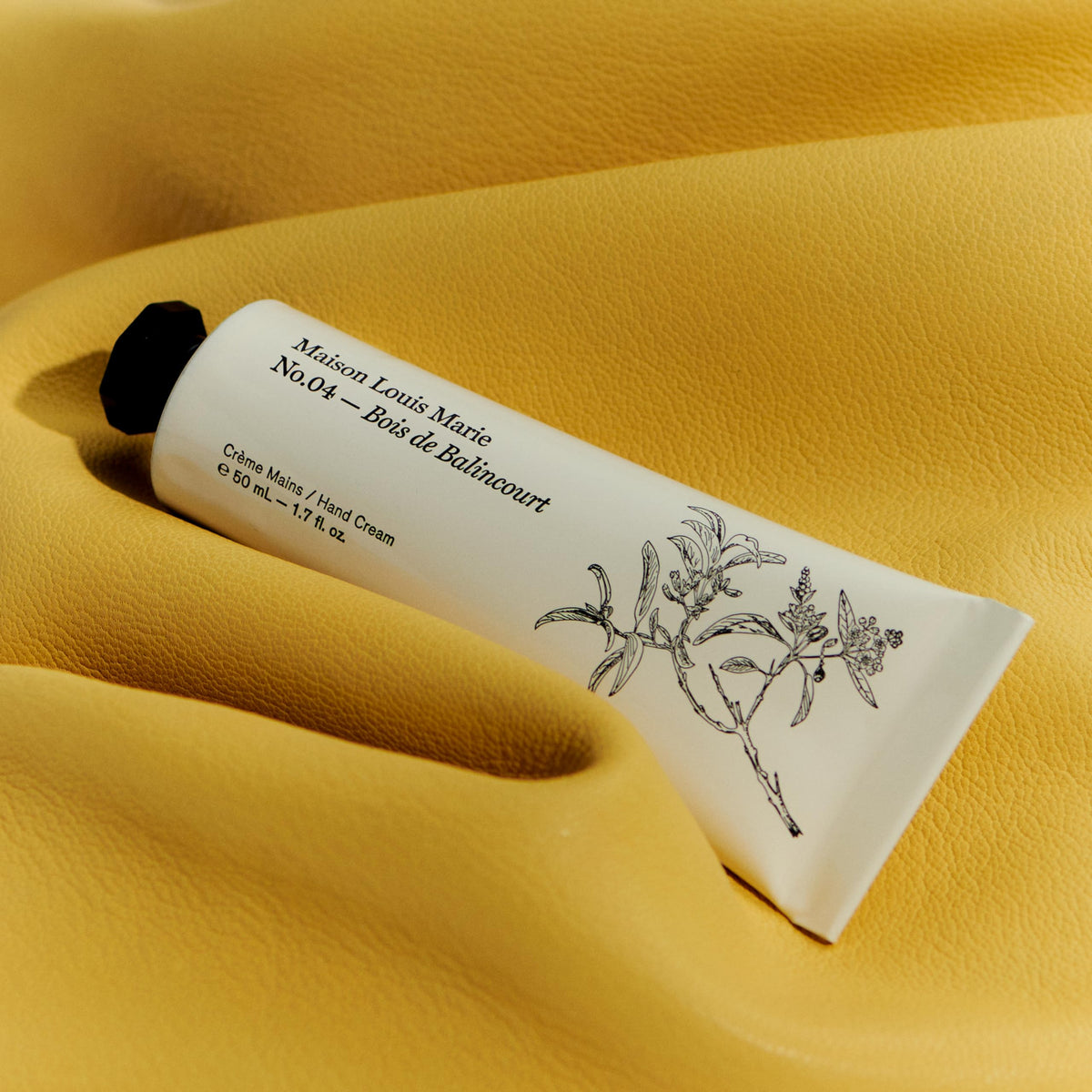 Maison Louis Marie No.04 Bois De Balincourt hand cream texture shown, hinting at rich hydration.