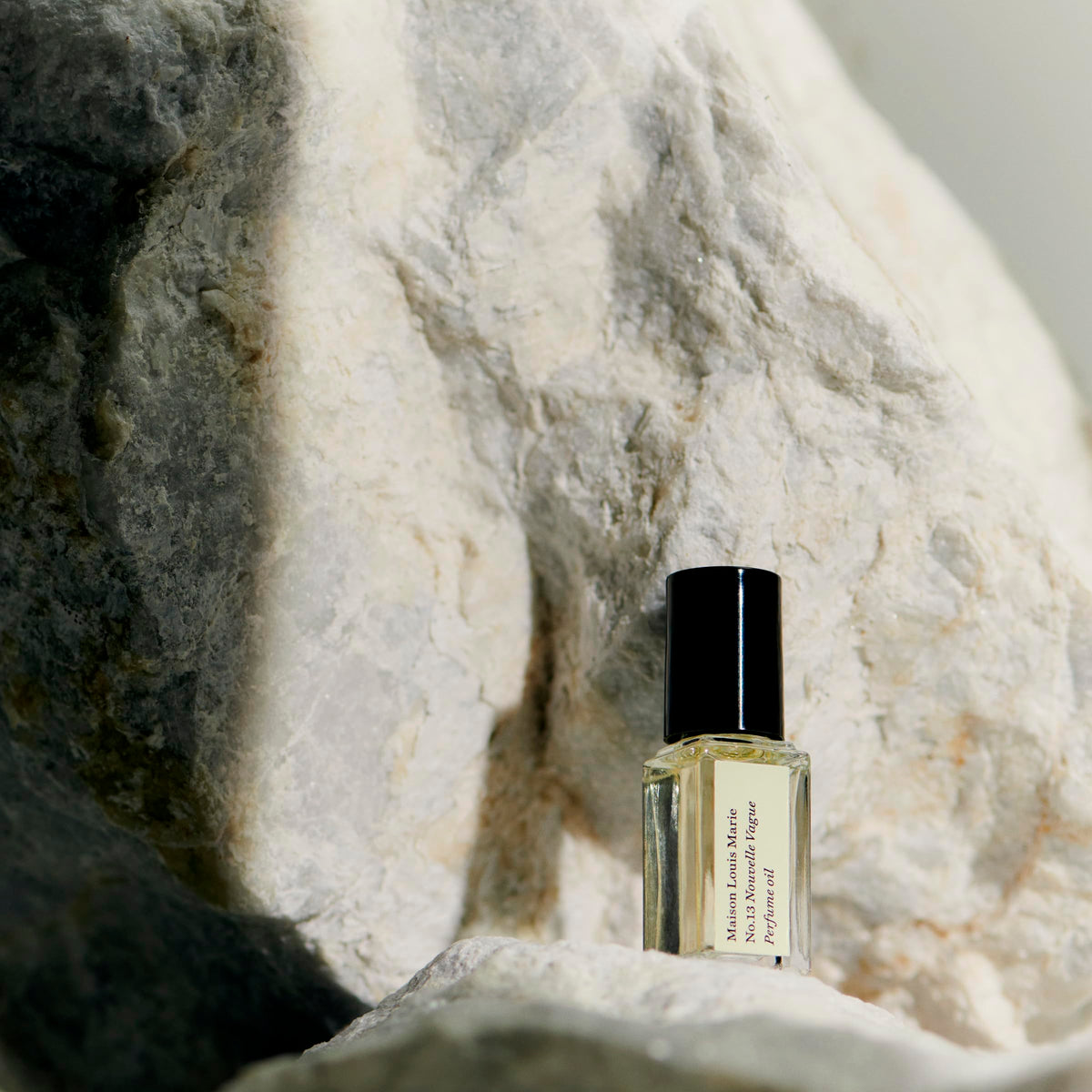 Maison Louis Marie No13 Nouvelle Vague vial closeup highlighting natural fragrance