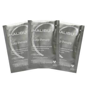 Malibu C Scalp Therapy crystals dissolving in hand for soothing scalp treatment