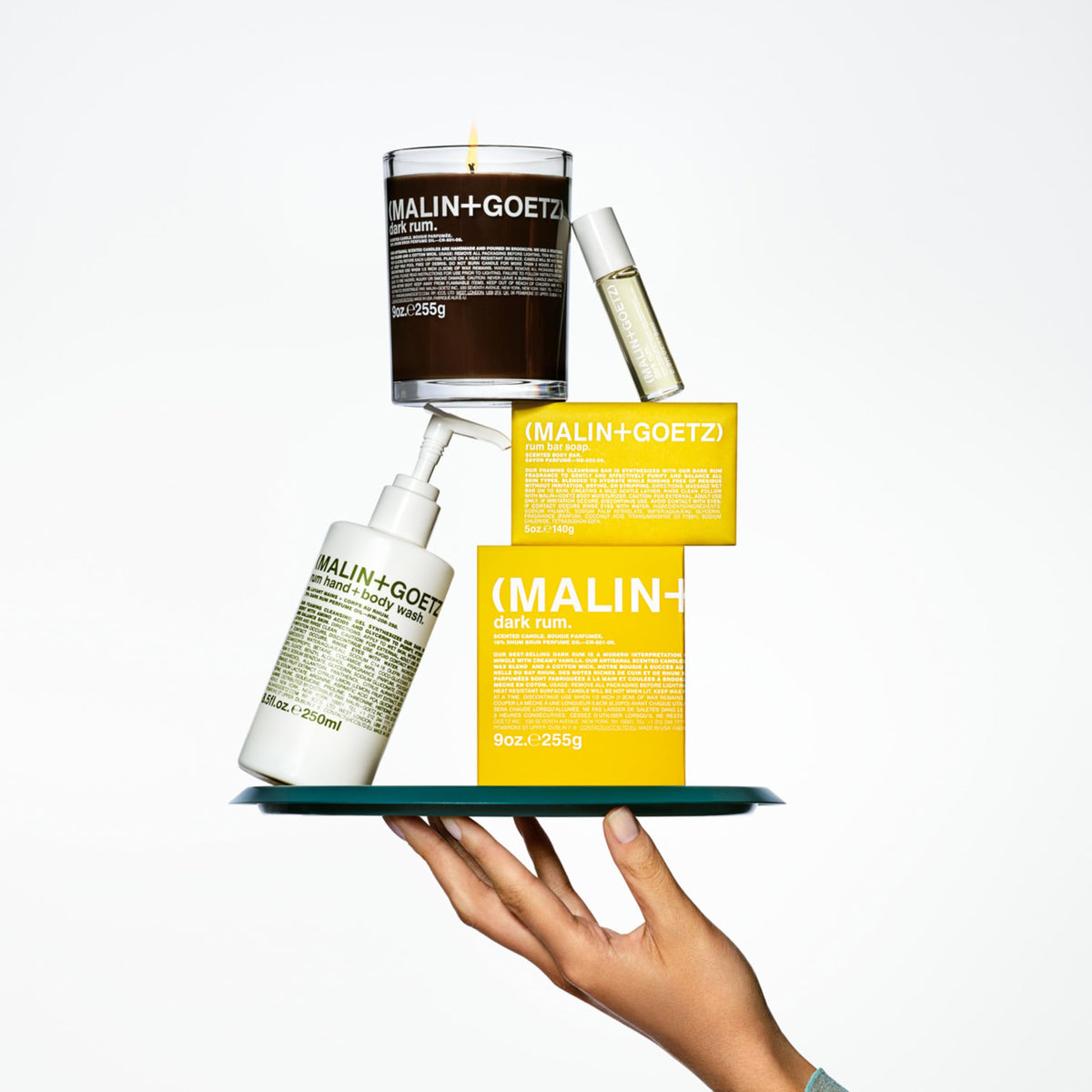 MALIN+GOETZ Rum Body Lotion applied on skin for hydration.