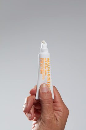 Close-up of MALIN+GOETZ SPF 30 lip balm UV shield