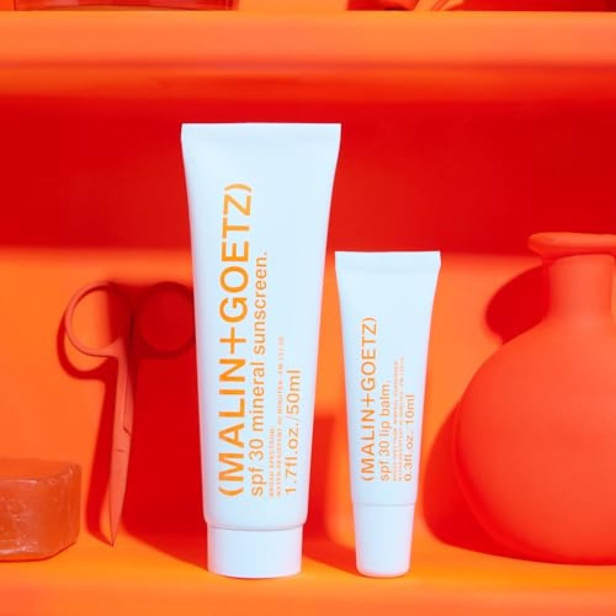 MALIN+GOETZ hydration complex on skin with subtle glow.