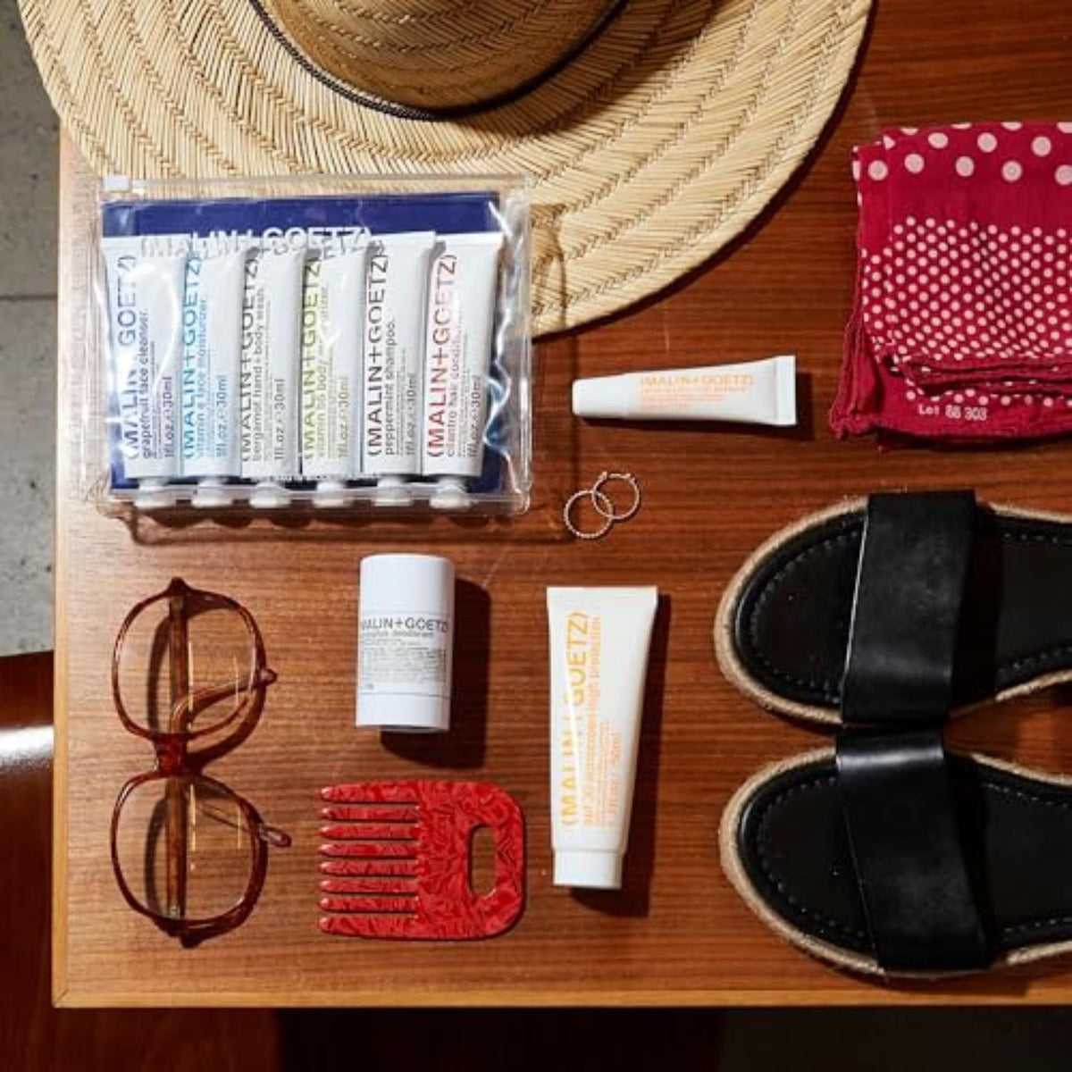 MALIN+GOETZ packaging with pump for travel-ready sun protection.
