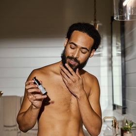 Bathroom counter view of MANSCAPED Beard Oil for daily routine.