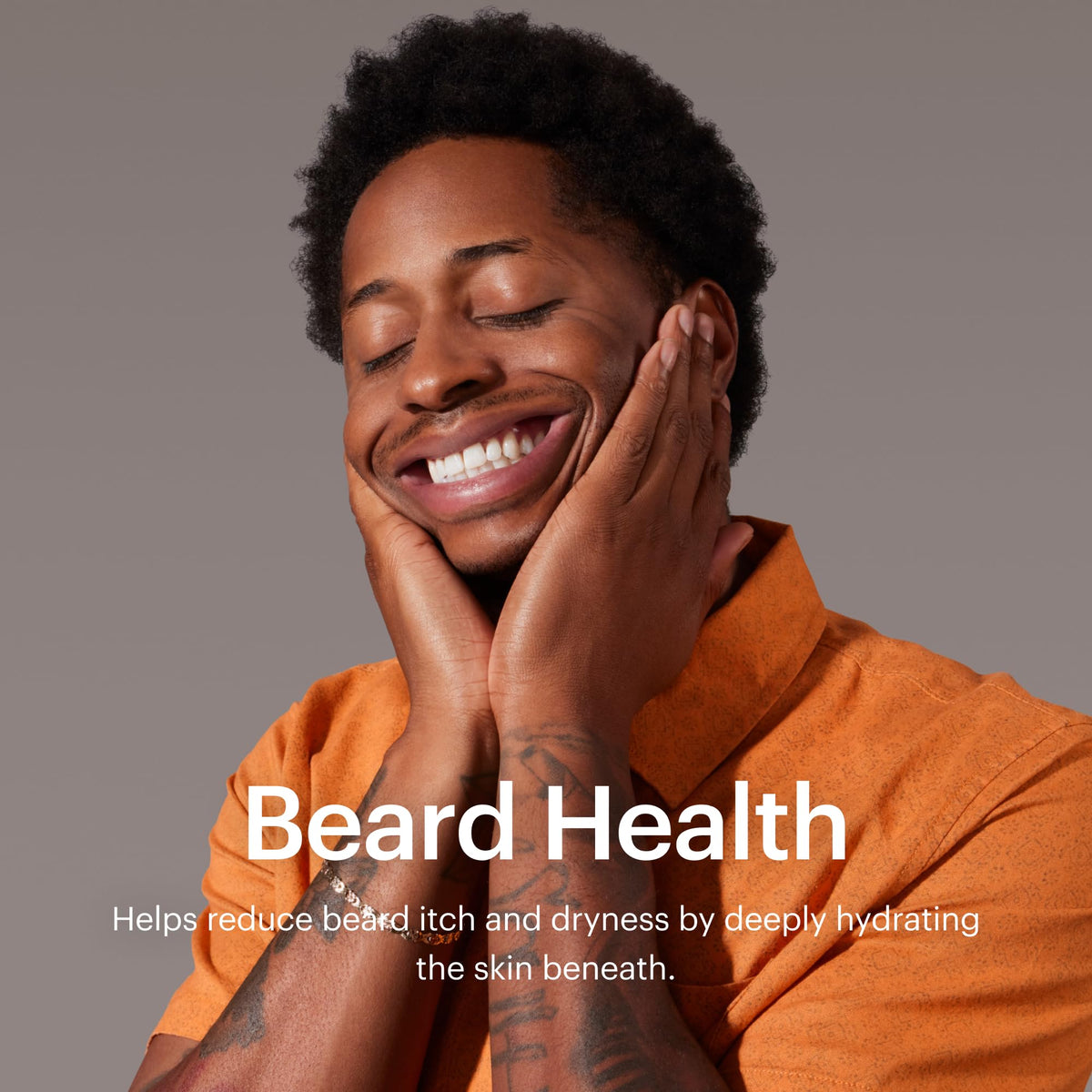 Beard brush beside MANSCAPED Beard Oil during application.