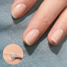 Manucurist Green Base Coat bottle priming nails for smooth application.