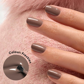Manucurist Green Freckles brown nail polish in cozy wood-toned shade.
