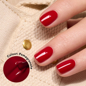Manucurist Green Pomegranate brush applying polish for smooth coverage.