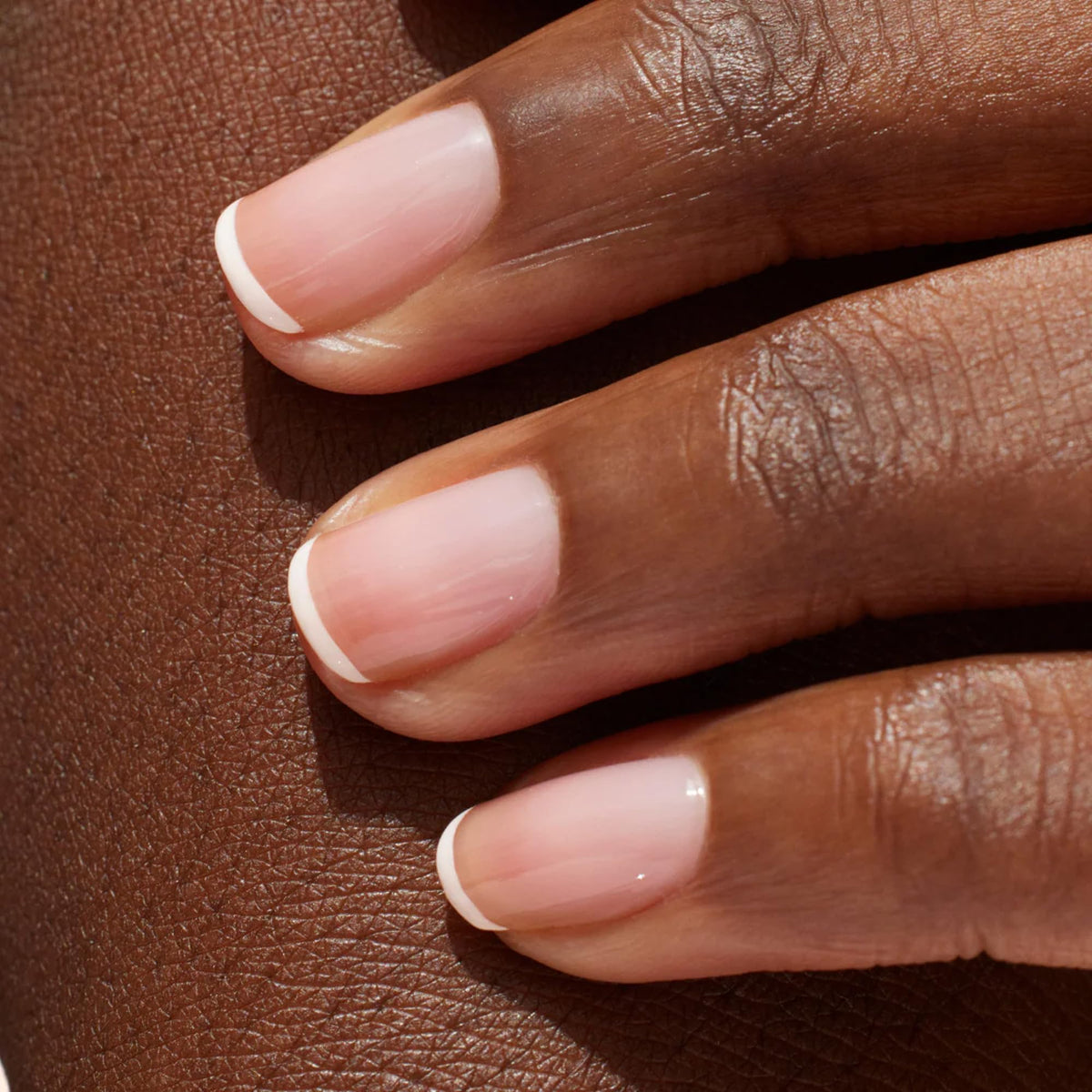 Manucurist natural-looking French glow on nails with fresh finish.