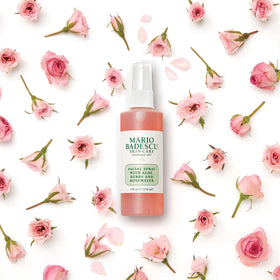 User applying Mario Badescu facial spray to face for hydration