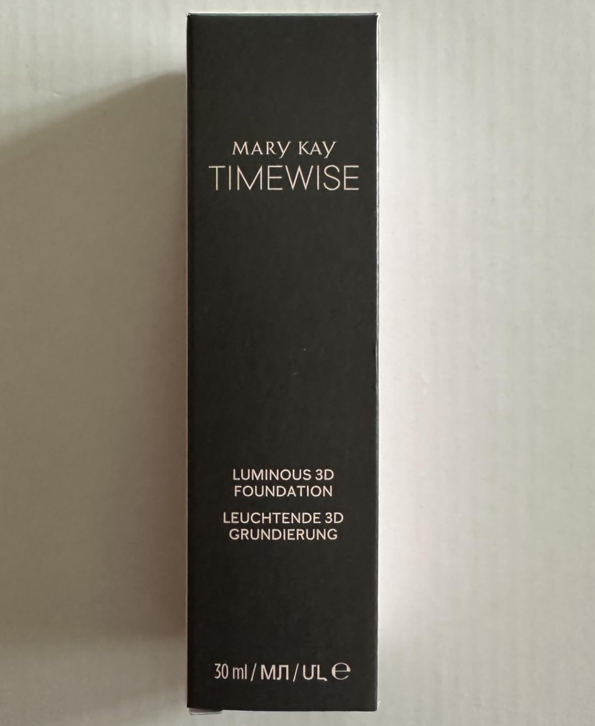 Close-up texture of Mary Kay TimeWise Luminous 3D Foundation on skin, even-toned.