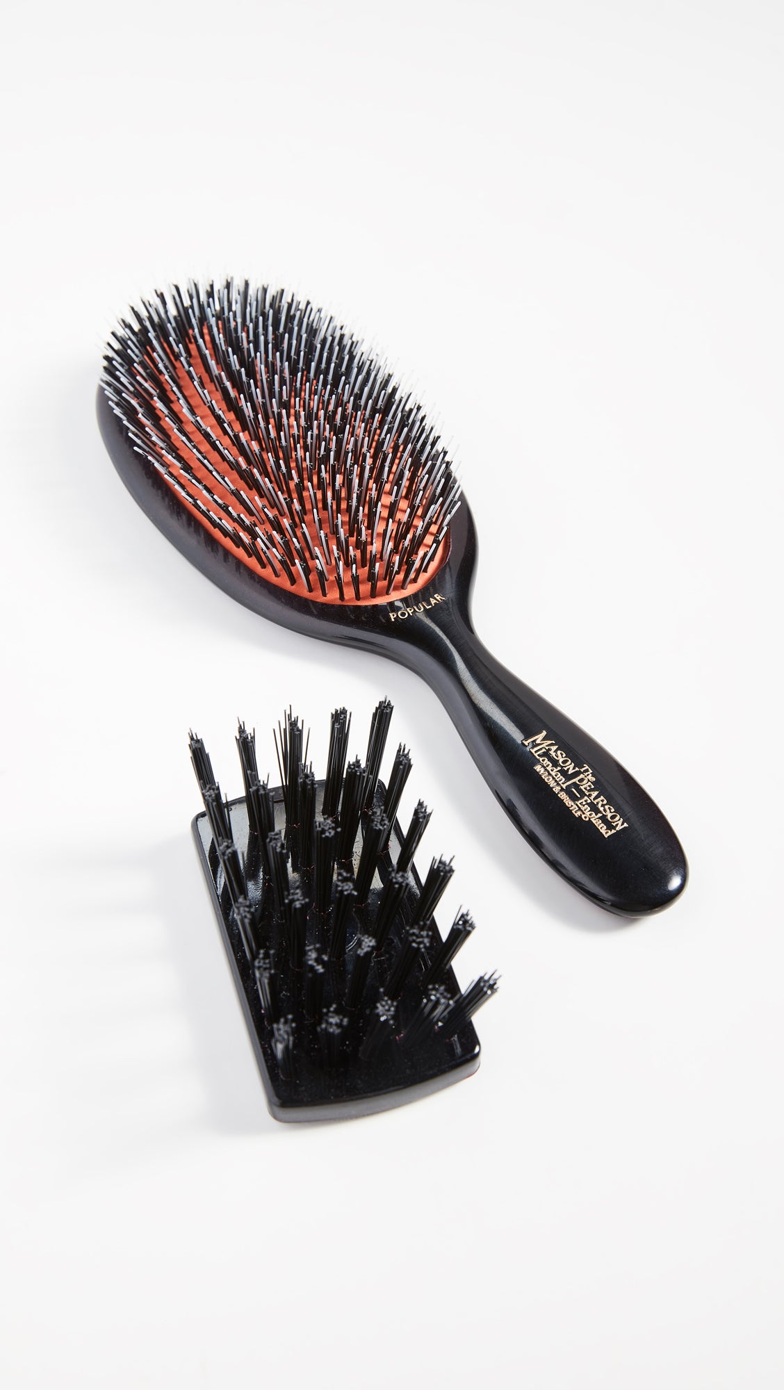 Mason Pearson Popular Mixture Brush in hand ready for daily brushing to distribute oils.