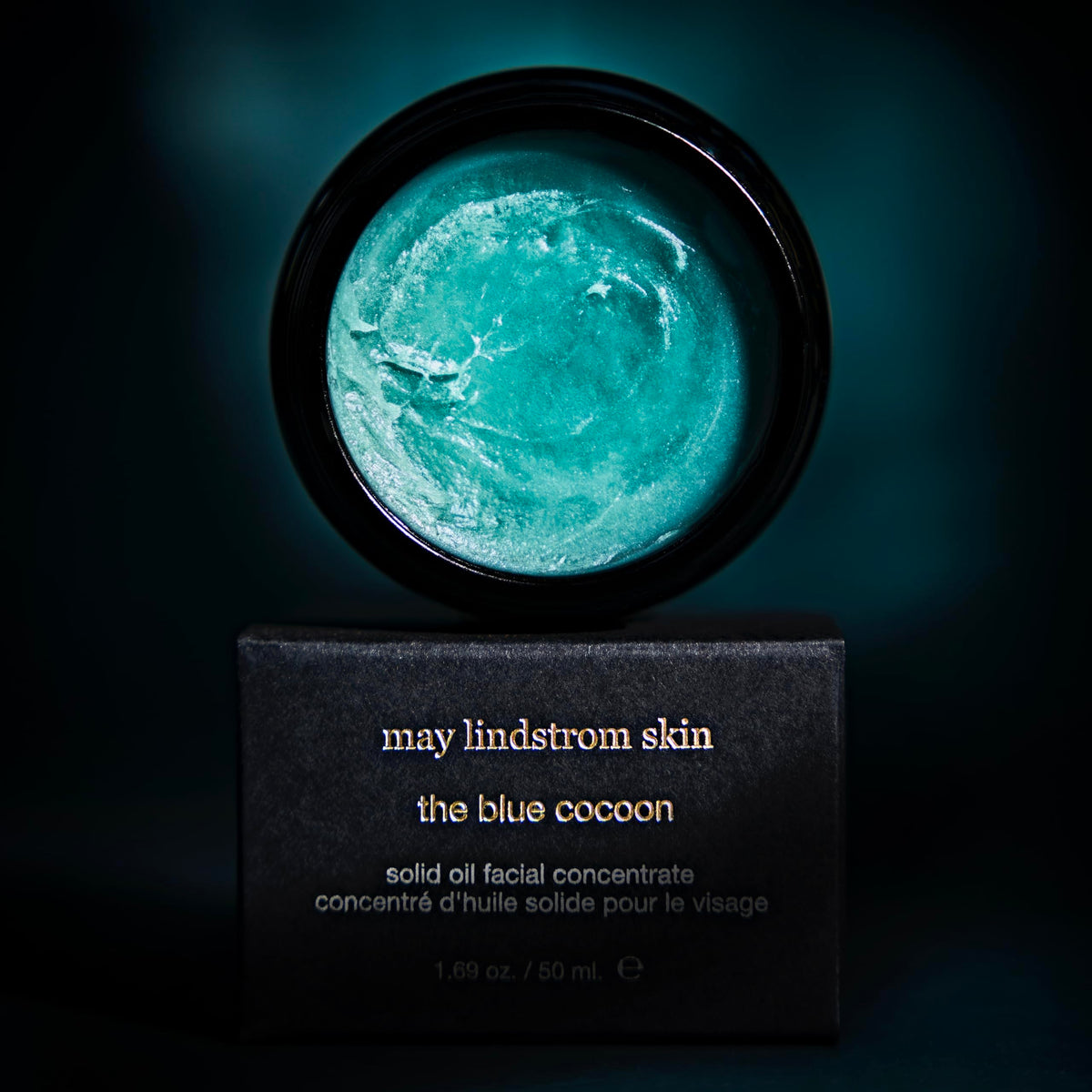 May Lindstrom Skin The Blue Cocoon balm-on-hand shows a nourishing, soothing texture.