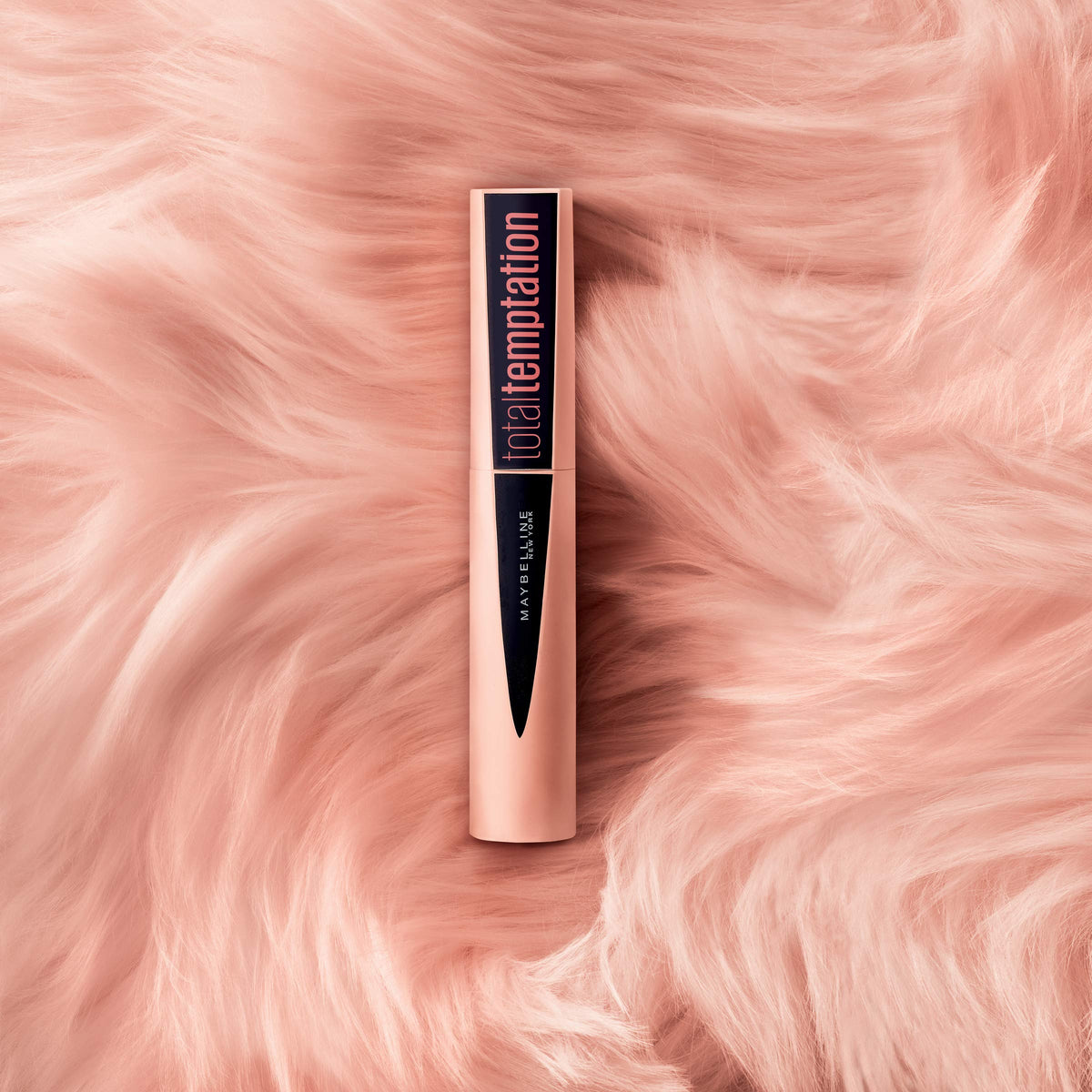 Model lashes wear Maybelline Total Temptation for fluffy finish.