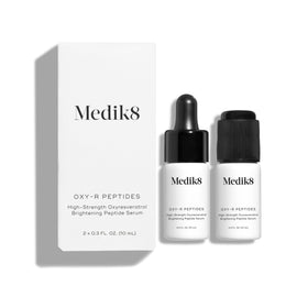 Medik8 Oxy-R Peptides Serum bottle on a clean vanity for even skin tone.