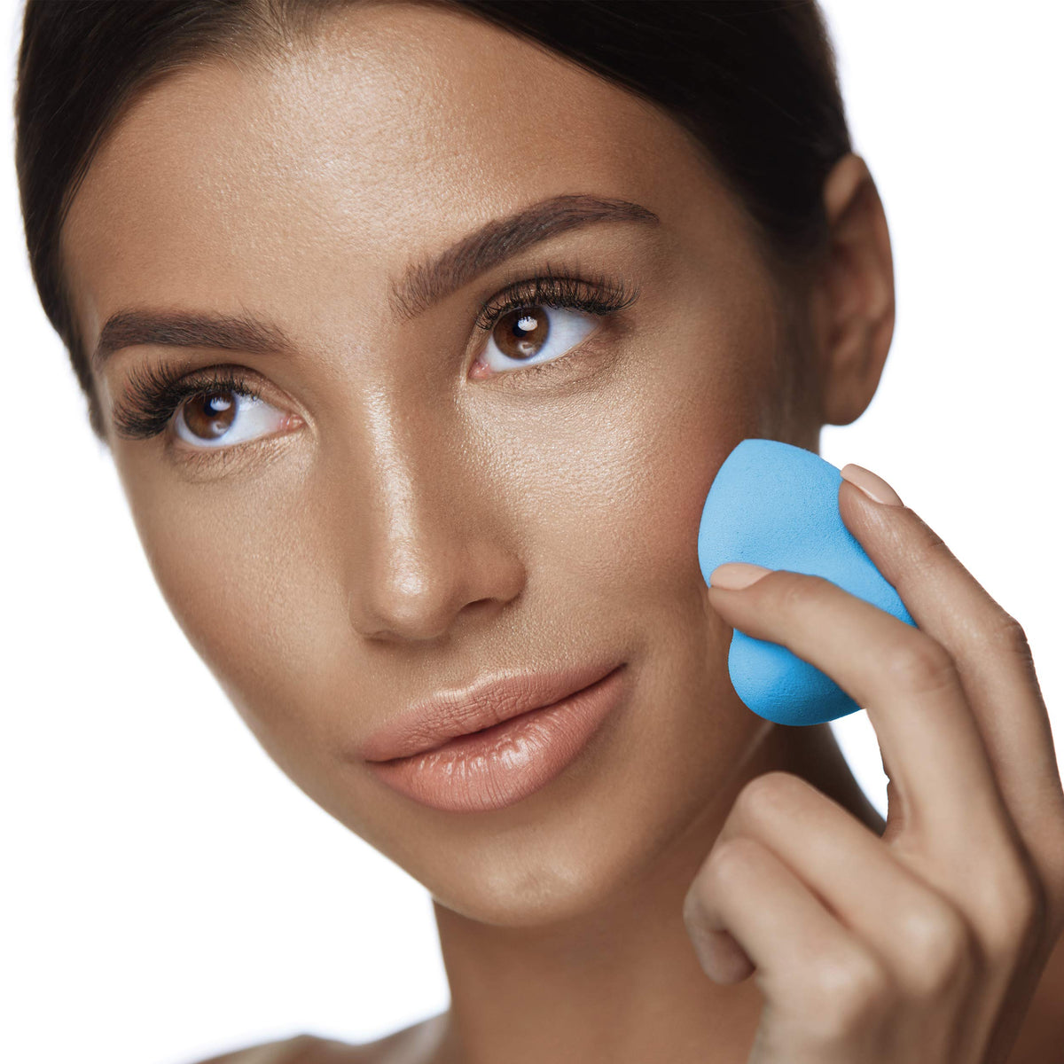 Dry application of Mehron StarBlend Cake Light Buff for natural coverage.
