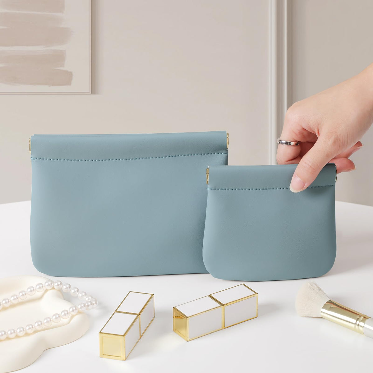 MEIBOOCH blue makeup bag open to reveal interior pockets for organization.