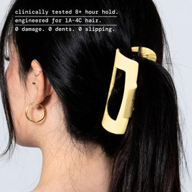 Mello squishy yellow medium hair clip worn on head for comfortable wear.