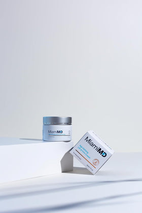 User applying cream in skincare routine for firming support.