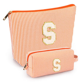Mibasies initial makeup bag orange open shows roomy interior for travel essentials and easy packing.