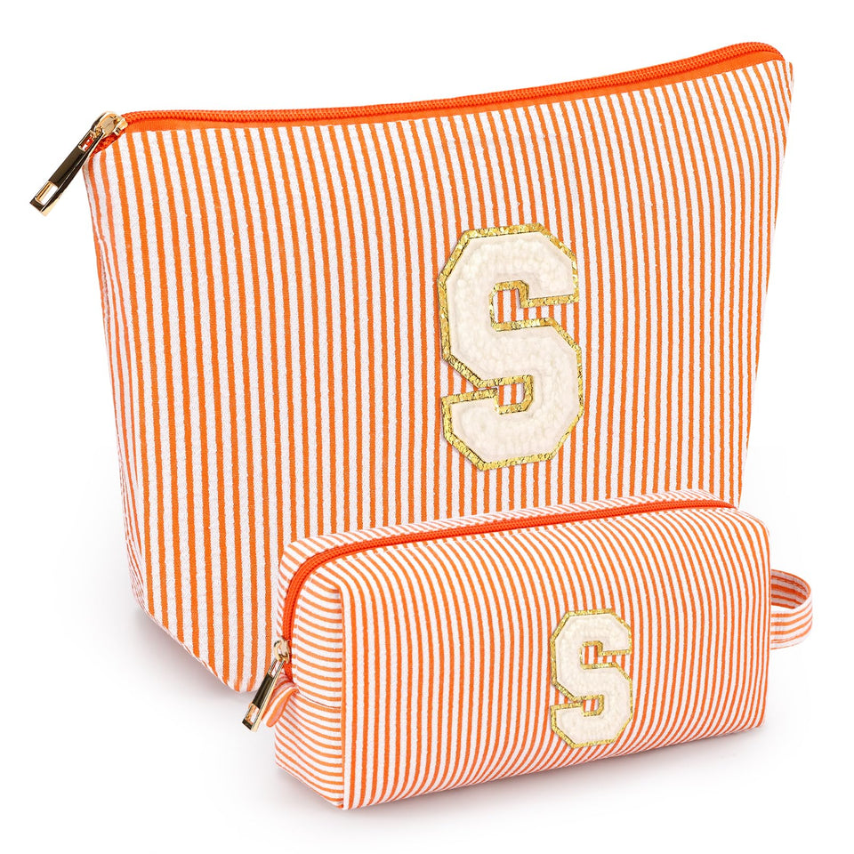 Mibasies initial makeup bag orange open shows roomy interior for travel essentials and easy packing.
