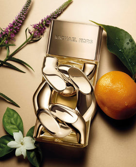 Michael Kors Pour Femme bottle with gold cap highlighting luxury appeal.