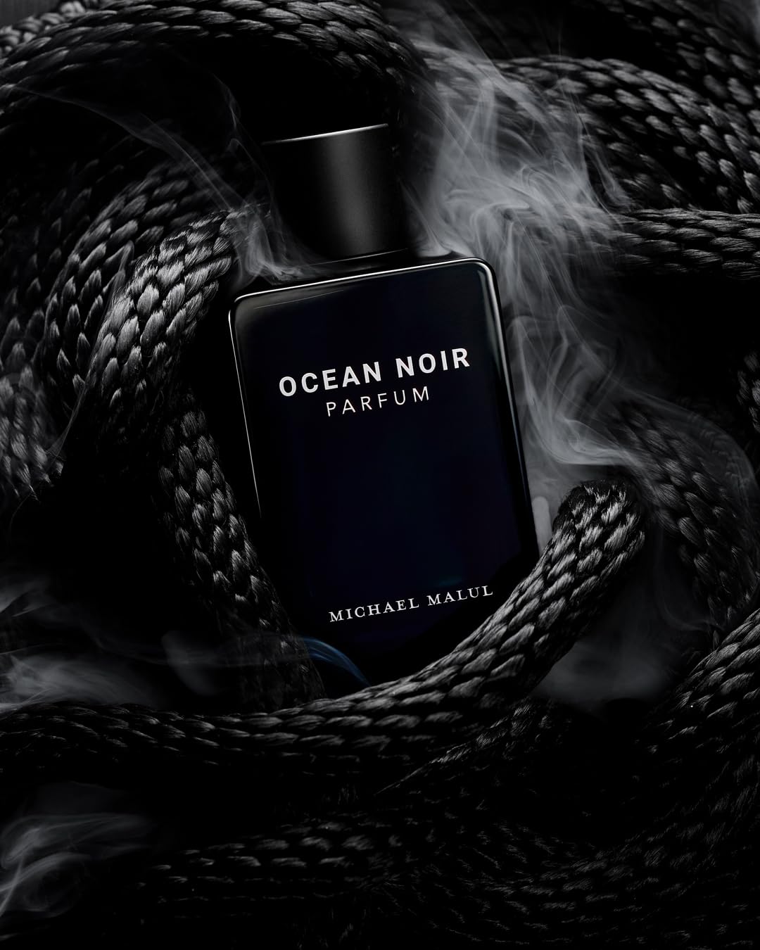 Parfum bottle on wood surface suggests versatile day-to-night use