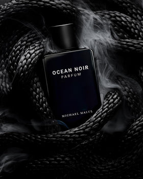 Parfum bottle on wood surface suggests versatile day-to-night use